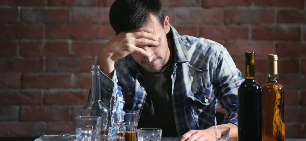 Man struggling with drinking alcohol.