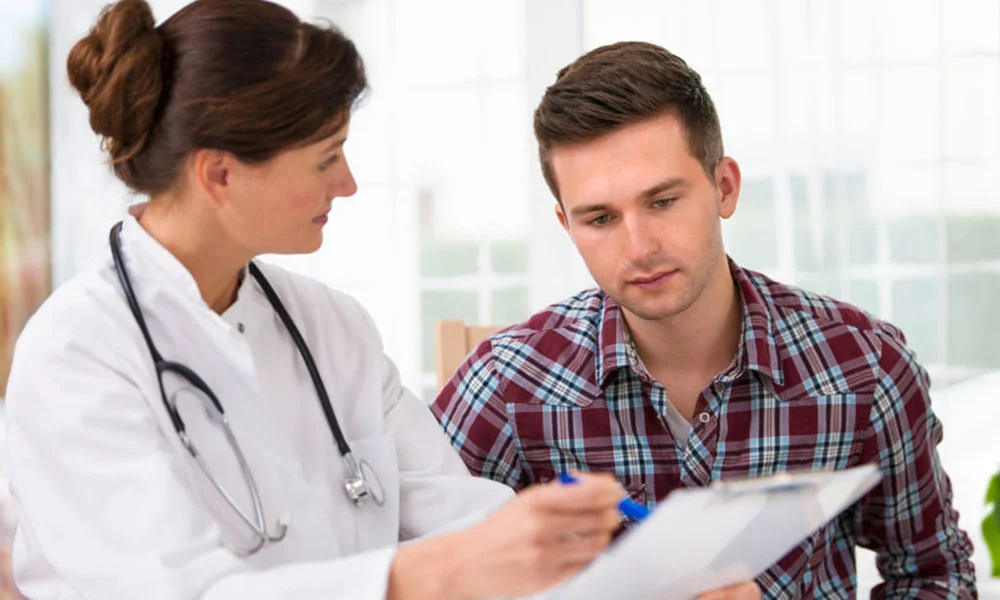 Doctor with client reviewing notes.